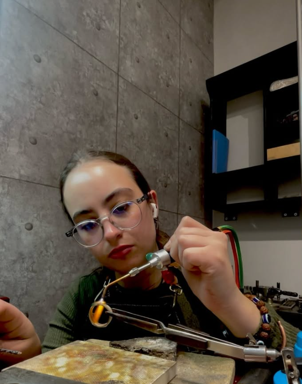 Taryn using a jeweller's torch at her workbench