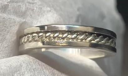 Sterling silver ring with a hand-twisted metal band accent