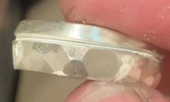 Close-up of hammered and textured detail on a sterling silver ring