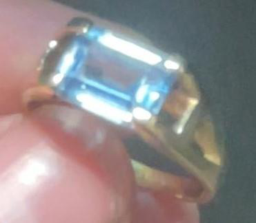 Close-up of a blue stone ring setting with a rectangular blue stone