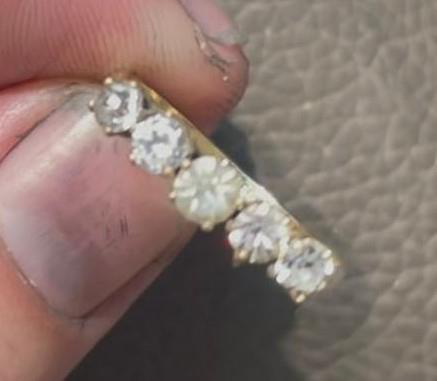 Close-up of a multi-stone ring with multiple stones in a gold setting